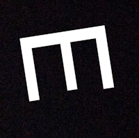 a white letter m on a black background